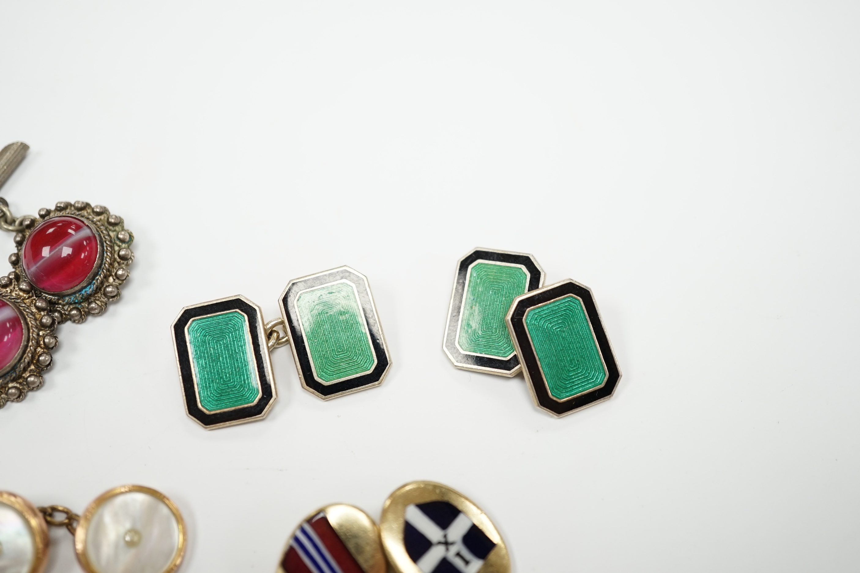 Four assorted pairs of cufflinks including silver and two coloured enamel.